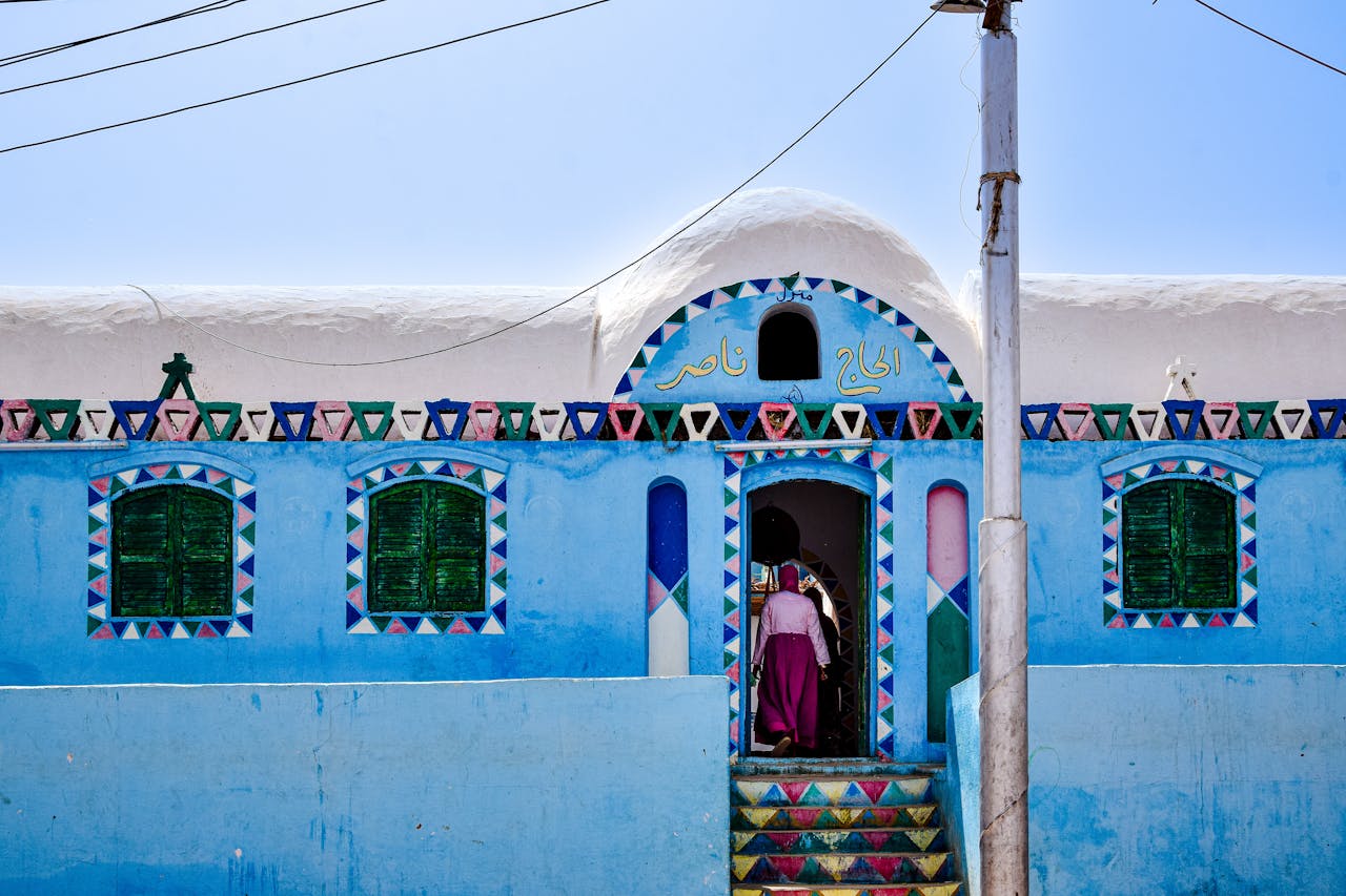 Vibrant blue house with geometric patterns in Nubian Village, Aswan, Egypt.